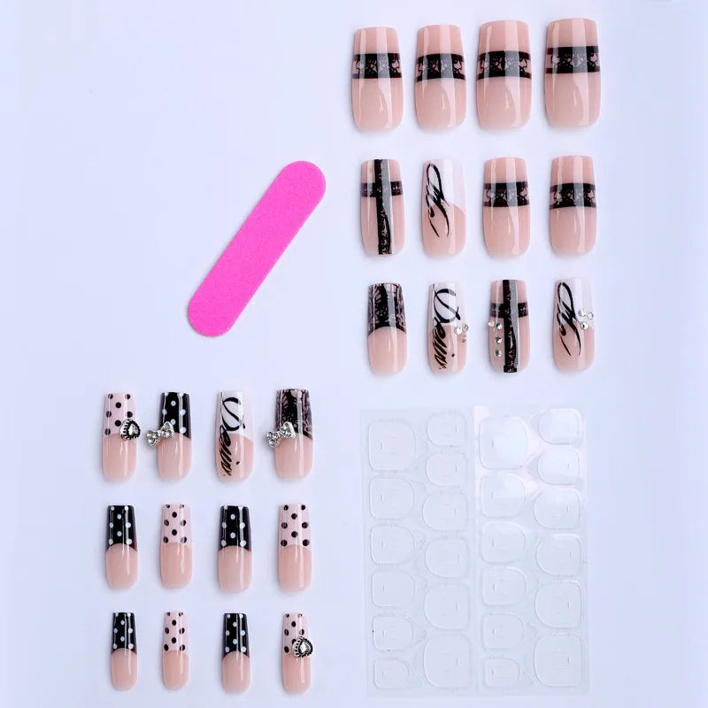 A set of gothic Y2K press-on nails featuring black and white designs with cross and bow motifs on a white background.