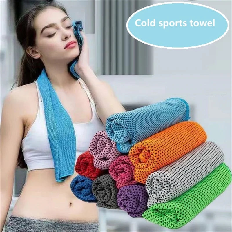 A woman is holding a blue sports towel next to various colored, rolled-up sport towels.