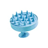A light blue wet and dry scalp massage brush with numerous pointed bristles.