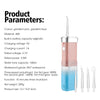 A pink and blue mini cordless water flosser oral irrigator with various tips shown.