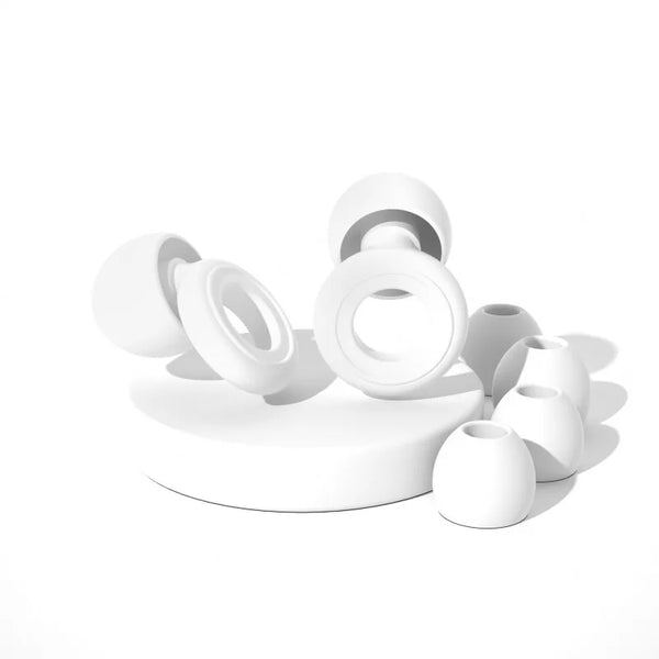 A collection of white silicone ear plugs for sleep and protection, shown from above.