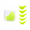 A set of bright lime green eyelash curlers and lifting tools displayed on a white background.