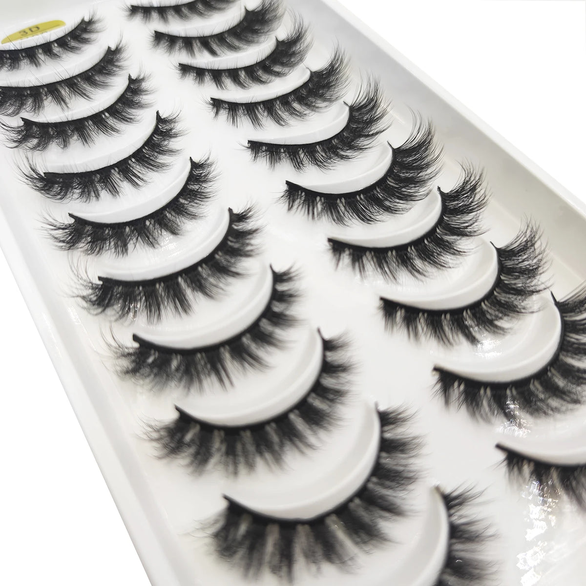 A display of natural 3D mink false eyelashes in various styles and lengths.