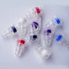 Several silicone earplugs in various colors including red, blue, and purple are shown scattered on a white surface.