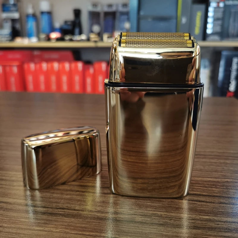 A sleek, metallic silver electric shaver with a textured head is displayed on a wooden surface.
