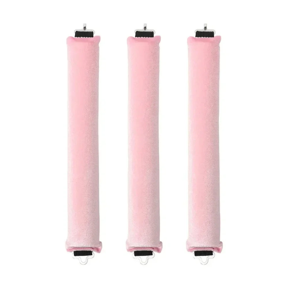 Three pink heatless hair curler curling rods standing vertically.