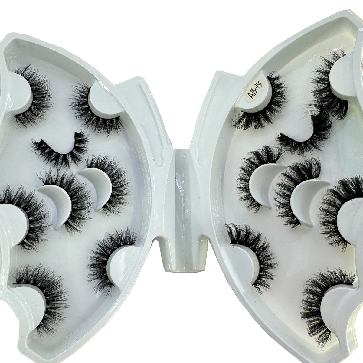 A pair of natural mink striped false eyelash extensions displayed in an open white plastic case.
