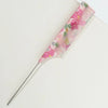 A pink floral dual hair comb with a metal prong is shown against a white background.