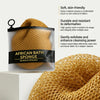 A clear pouch containing an African bath sponge made of yellow nylon is shown next to a pile of the same sponge.