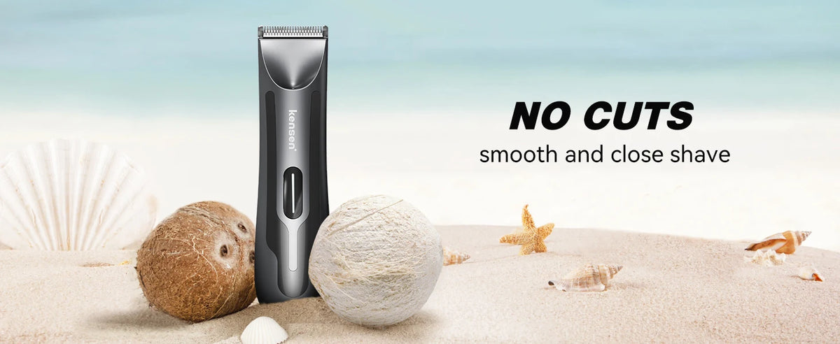 A black electric body hair trimmer stands next to natural sea elements like shells and sand.