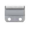 Silver replacement blade for professional hair clippers with a serrated edge and mounting holes
