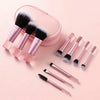 A pink travel makeup brush set featuring ten makeup brushes and a matching pink cosmetic pouch.