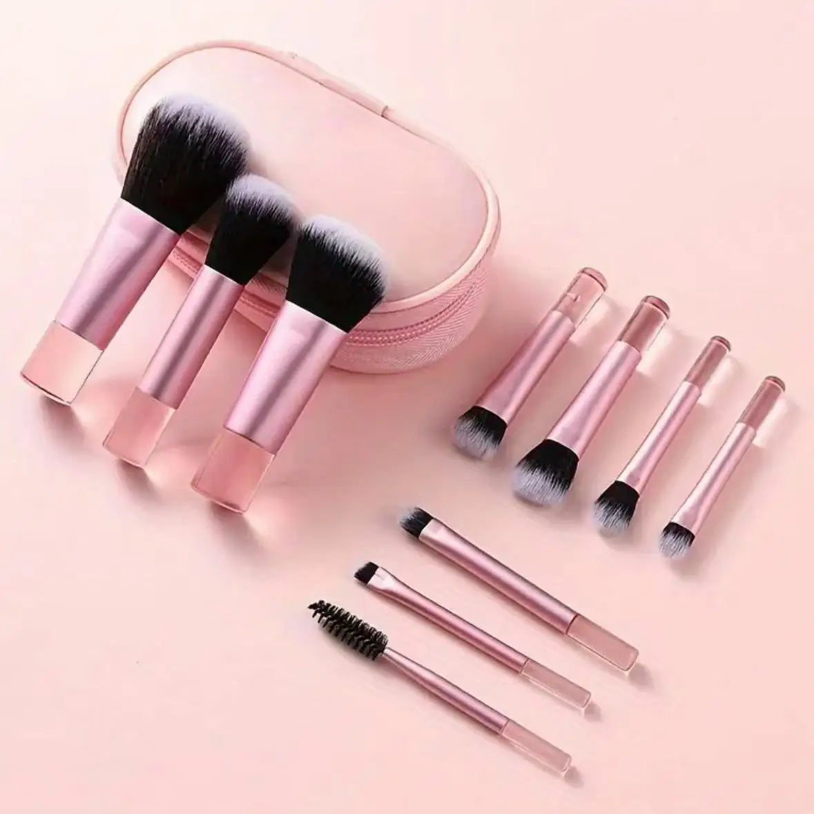 A pink travel makeup brush set featuring ten makeup brushes and a matching pink cosmetic pouch.