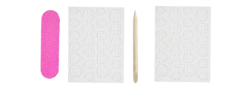 A set of Y2K almond press-on nails including a pink nail and a wooden cuticle pusher.
