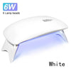 A white portable UV LED nail dryer lamp with six lamp beads shown illuminating a surface.