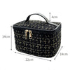 Black knitted canvas makeup pouch with a handle and gold-toned clasps.