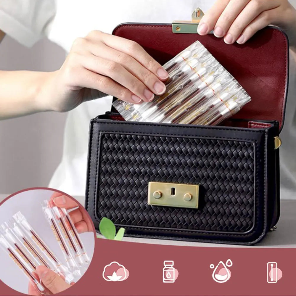 A hand is placing disposable medical iodine cotton swabs into a black leather storage case.