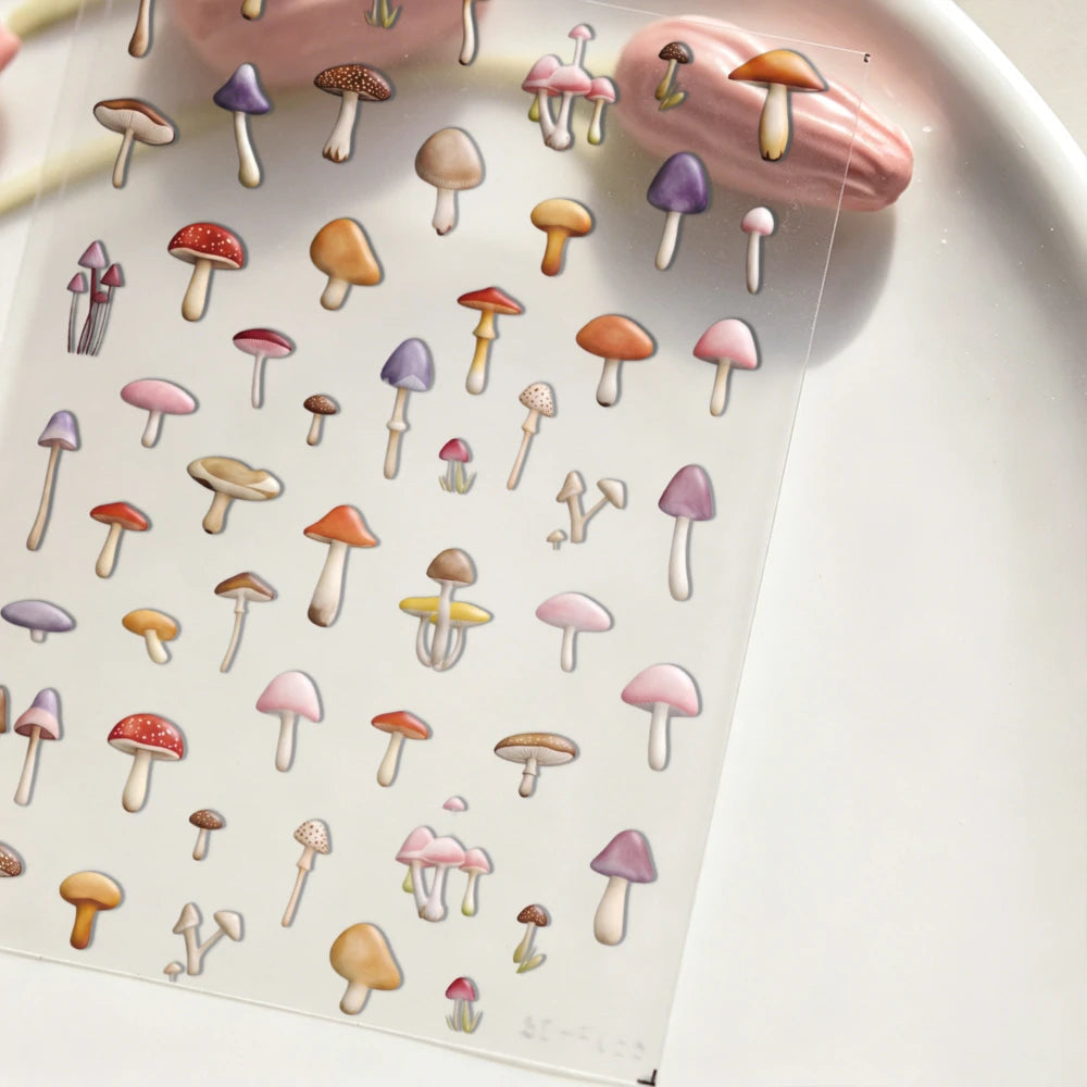A sheet of watercolor mushroom nail art stickers featuring various sizes and colors of mushrooms.
