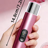 A hand holds a pink electric foot file callus remover device with a digital display showing 100% and a replacement disc conta