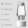 A clear precision scalp oil applicator bottle with a ball-tip massager and a white base.