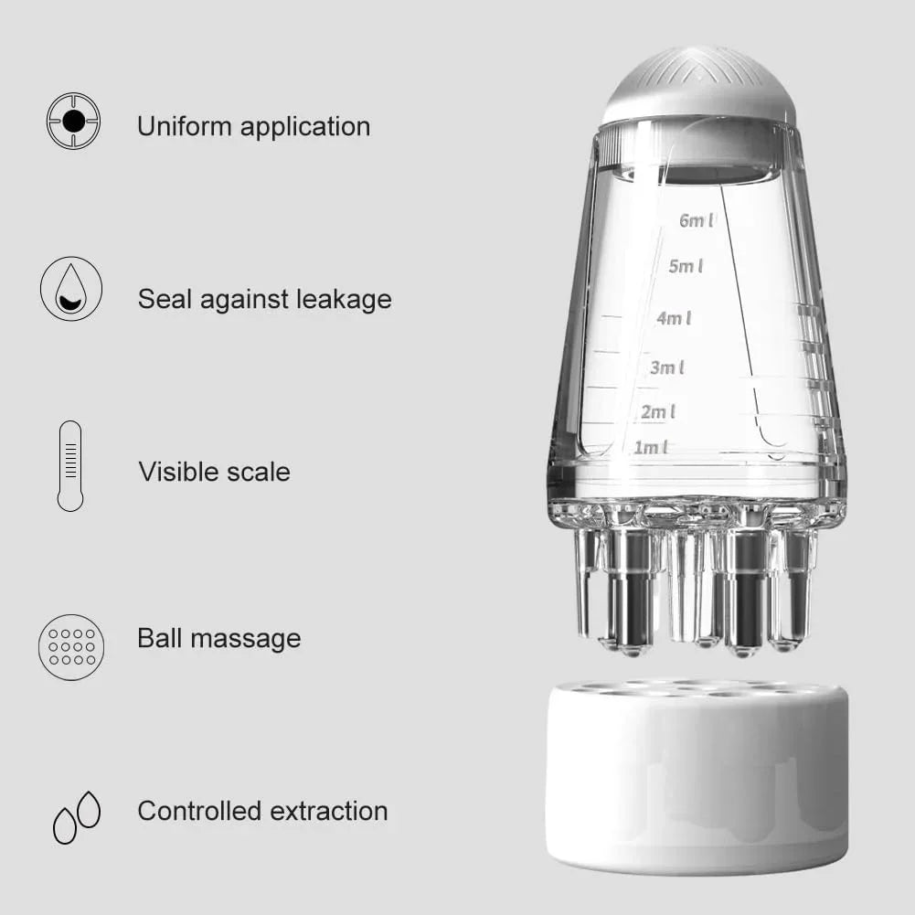 A clear precision scalp oil applicator bottle with a ball-tip massager and a white base.