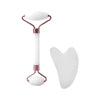 A set of two white resin facial massage rollers with rose gold accents.