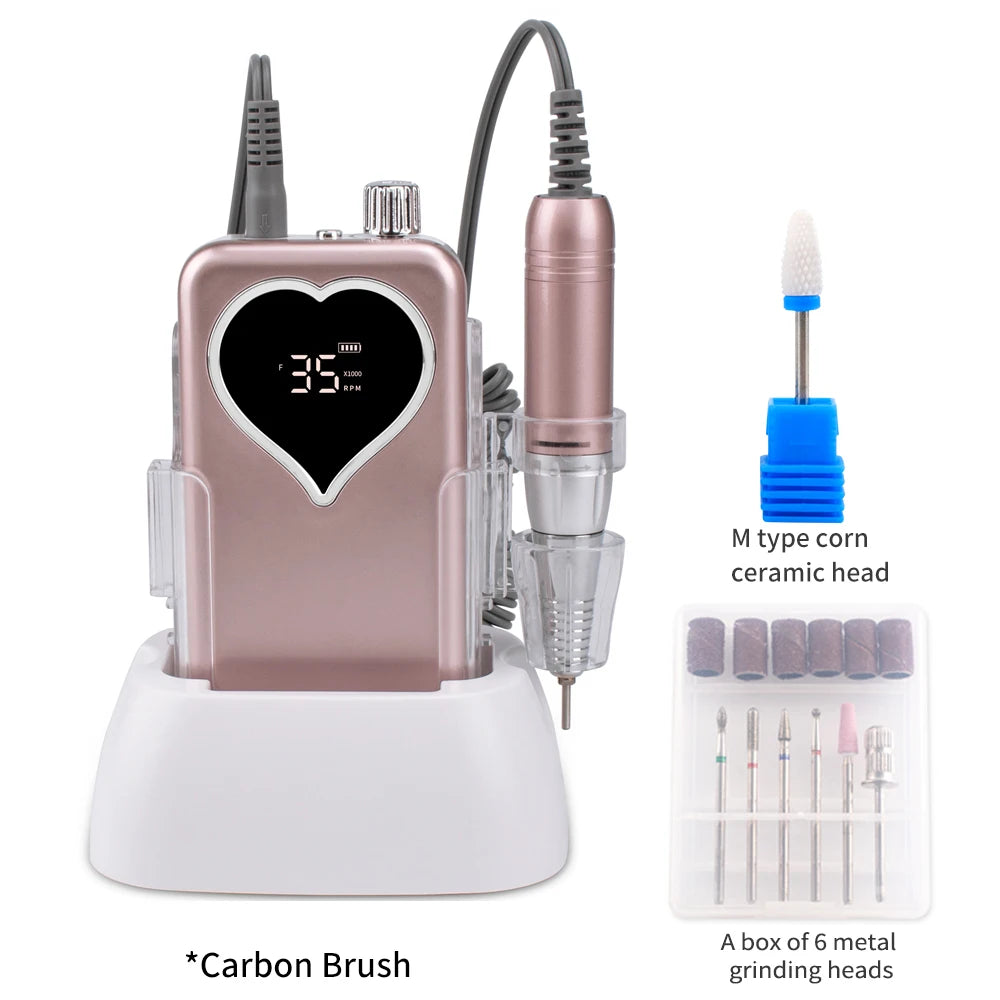 A pink cordless rechargeable nail drill with a ceramic head and a box of six metal grinding heads