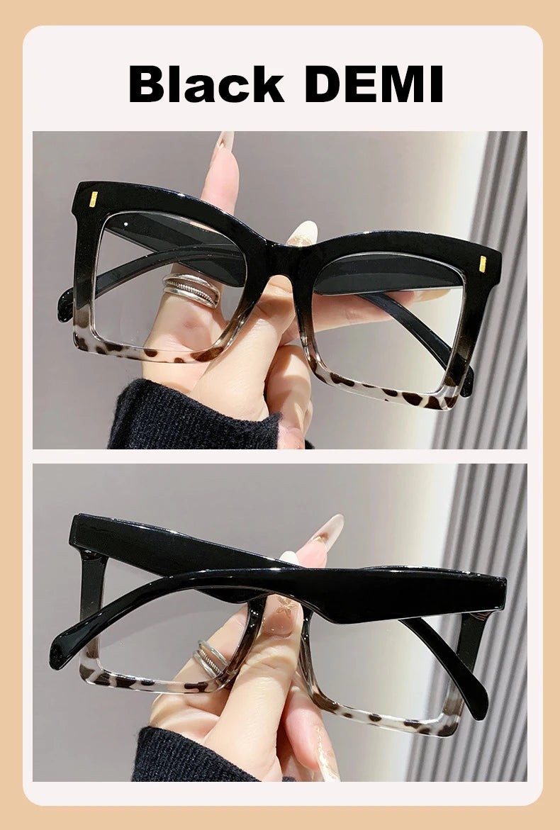 A pair of black demi sunglasses with tortoise shell accents shown in a close-up view.