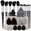 A complete makeup brush set featuring various sizes and shapes of soft synthetic bristles in black, gray, and white.