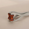 A light gray silicone finger massage roller with two wooden rollers visible.