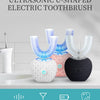 An ultrasonic U-shaped electric toothbrush in white, pink, and black resting on a white surface.