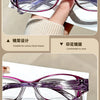 Purple-framed reading glasses shown being held by a hand, highlighting the design and comfort.