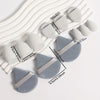A set of twelve white and gray makeup sponges arranged diagonally on a white background.