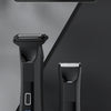 A black body hair trimmer and epilator device shown against a dark gray background.