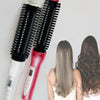 A pair of black and red ceramic hair straighteners or curlers are shown against a light gray background.