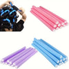 A collection of soft foam heatless hair rollers in pink and blue colors.