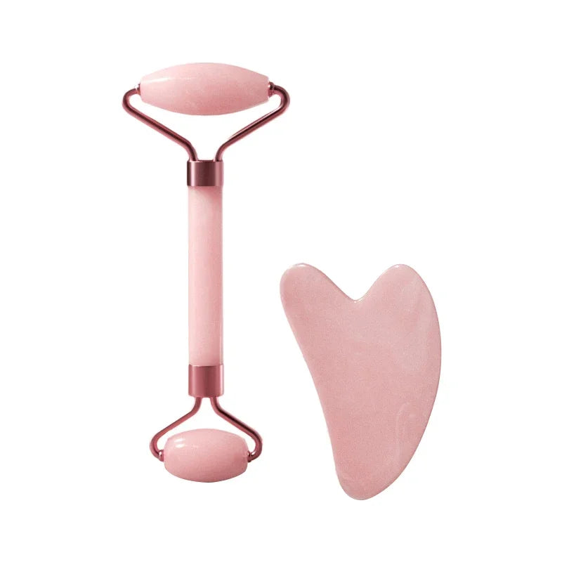 A pink jade gua sha tool set featuring a smooth stone and a metal handle.