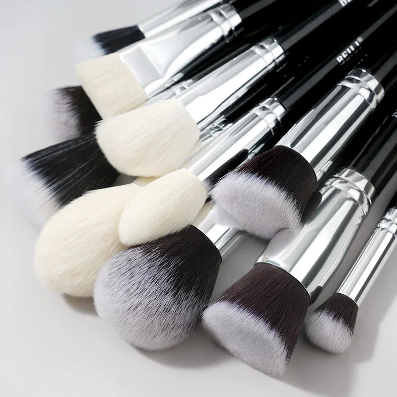 A collection of 30 professional makeup brushes with silver handles and various colored bristles.