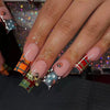 Press-on nails featuring a blue and brown French wave design with glitter accents and small insect motifs