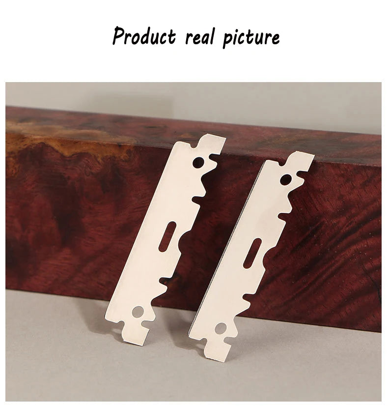 Two stainless steel single-sided razor blades resting on a dark wooden surface.