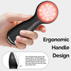 A hand holds a black vibrating LED facial cleansing brush with an ergonomic handle and an inclined brush head design.