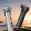 A silver and black electric shaver is shown resting on a rock near the ocean at sunset.