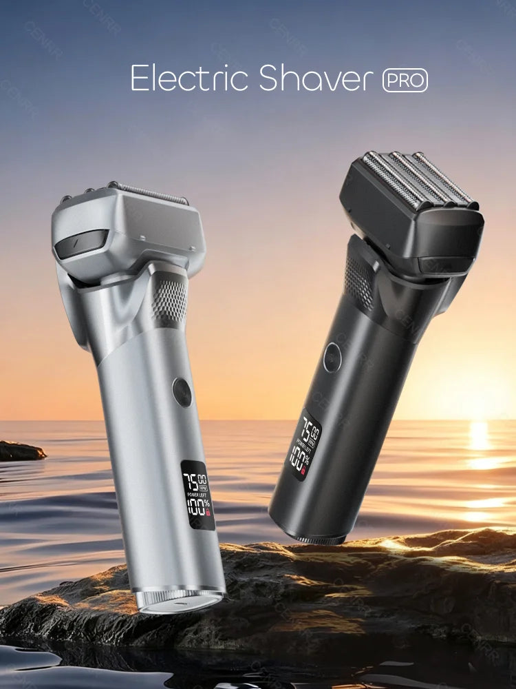 A silver and black electric shaver is shown resting on a rock near the ocean at sunset.