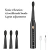 A black ultrasonic electric toothbrush with a detachable head and a charging cable.