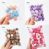 Various colors of reusable expandable makeup sponges packaged in clear plastic bags