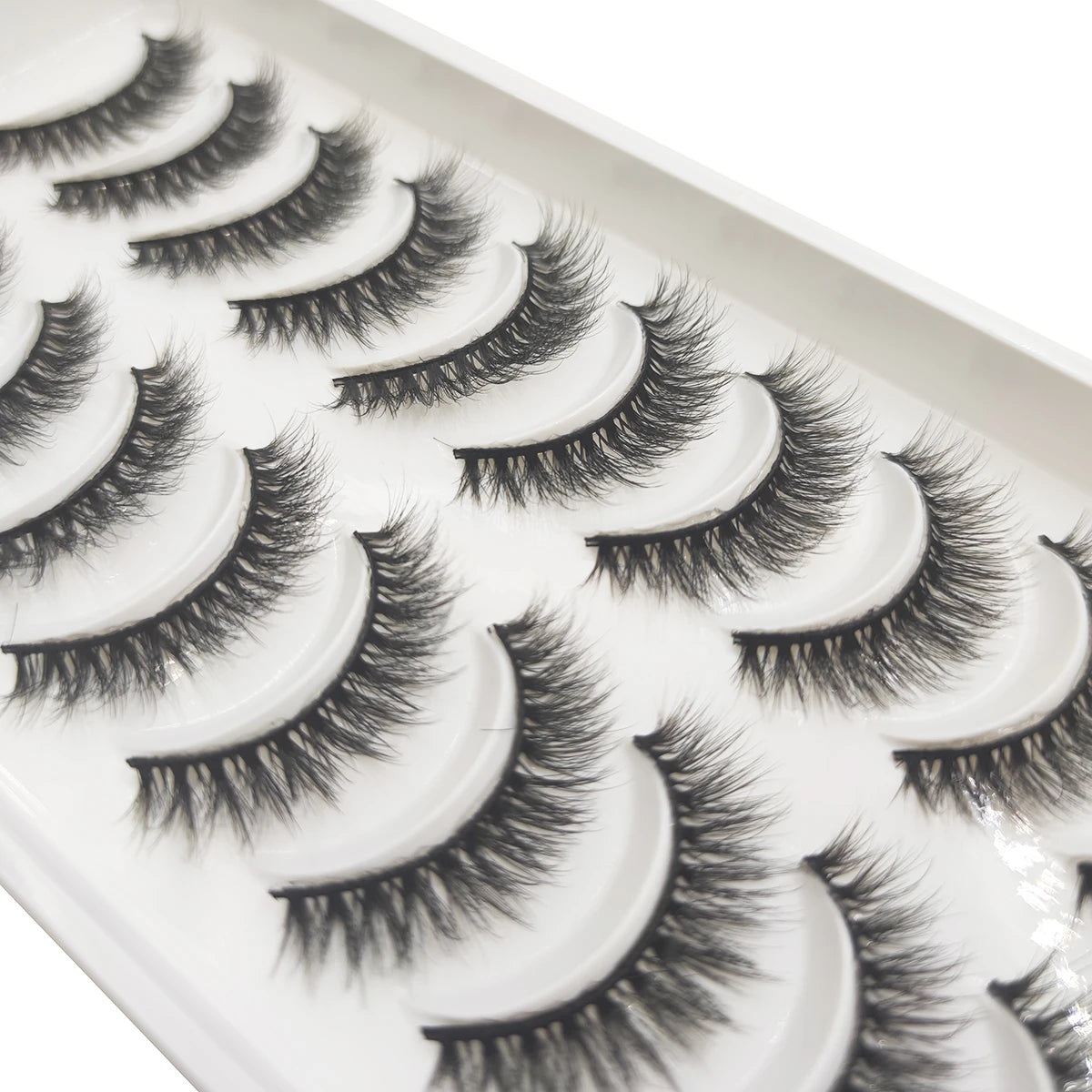 A display of natural 3D mink false eyelashes in a white tray.