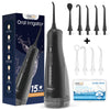 A black oral irrigator device shown with various tips and accessories in a box.