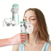 A woman is using a portable mesh inhale nebulizer device to inhale mist into her nose.