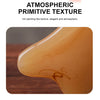 A close-up of an amber-colored product demonstrating an ink painting like texture for facial massage and lifting.