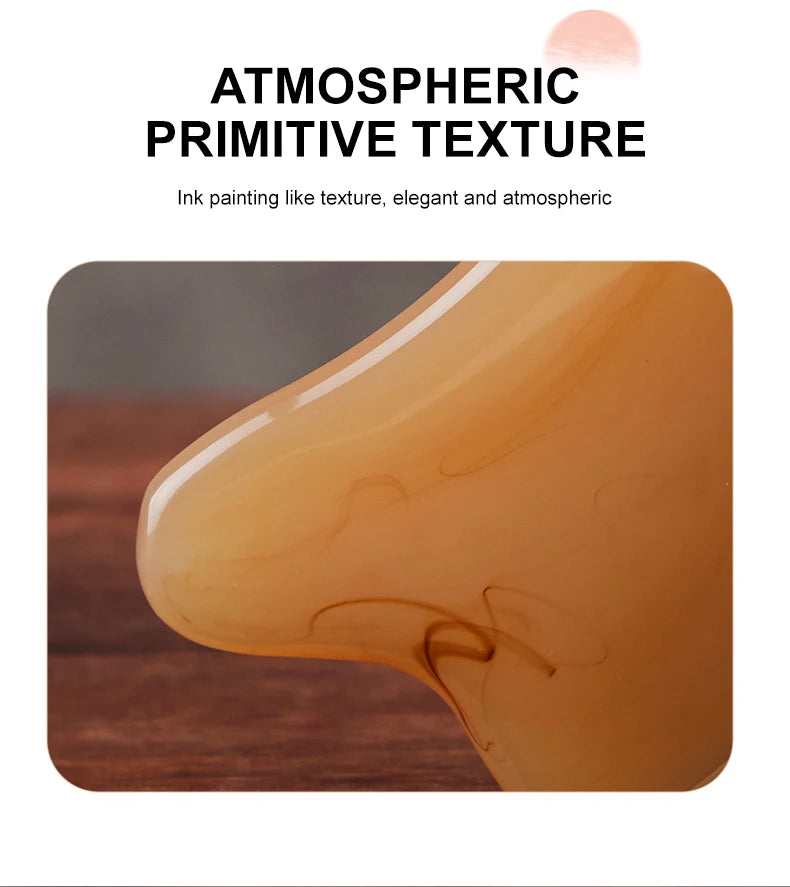 A close-up of an amber-colored product demonstrating an ink painting like texture for facial massage and lifting.
